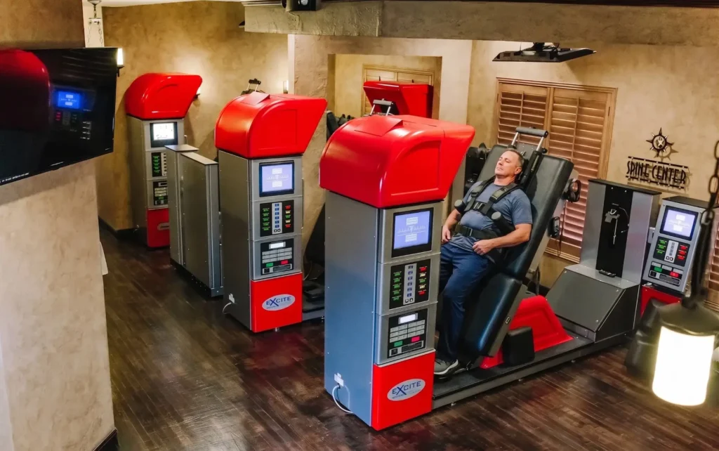 Patient undergoing spinal decompression therapy on a DRX-9000 machine to relieve lower back pain